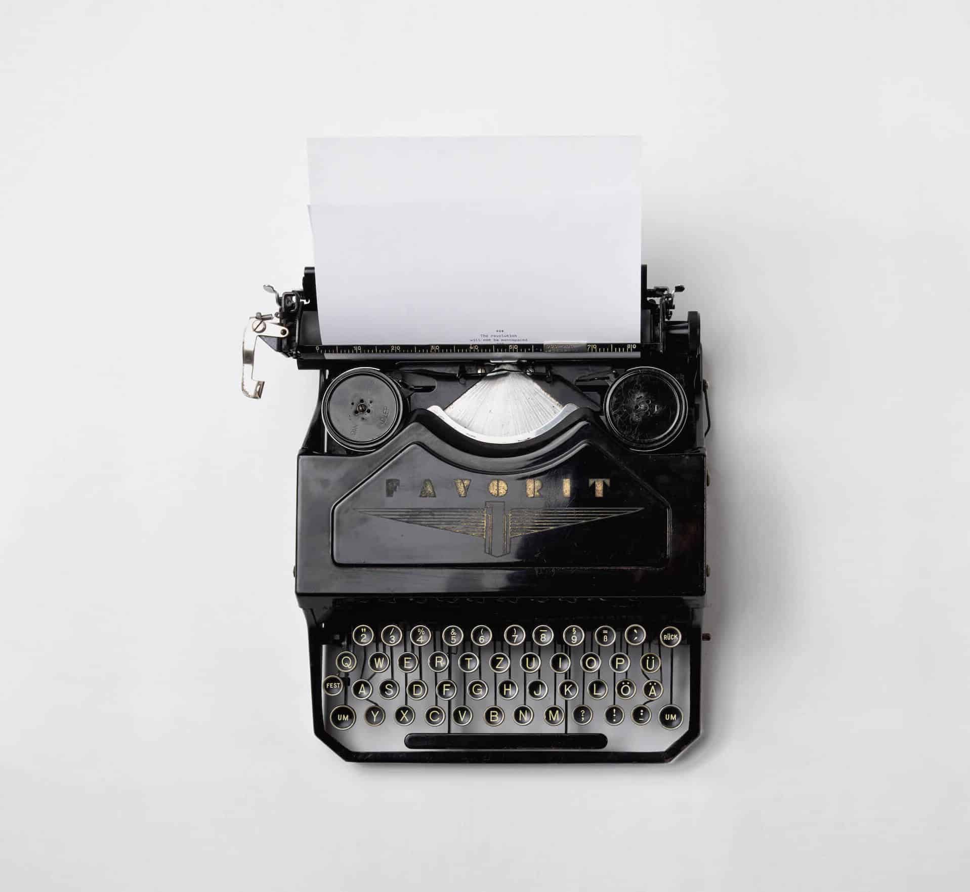 Old black typewriter on white background