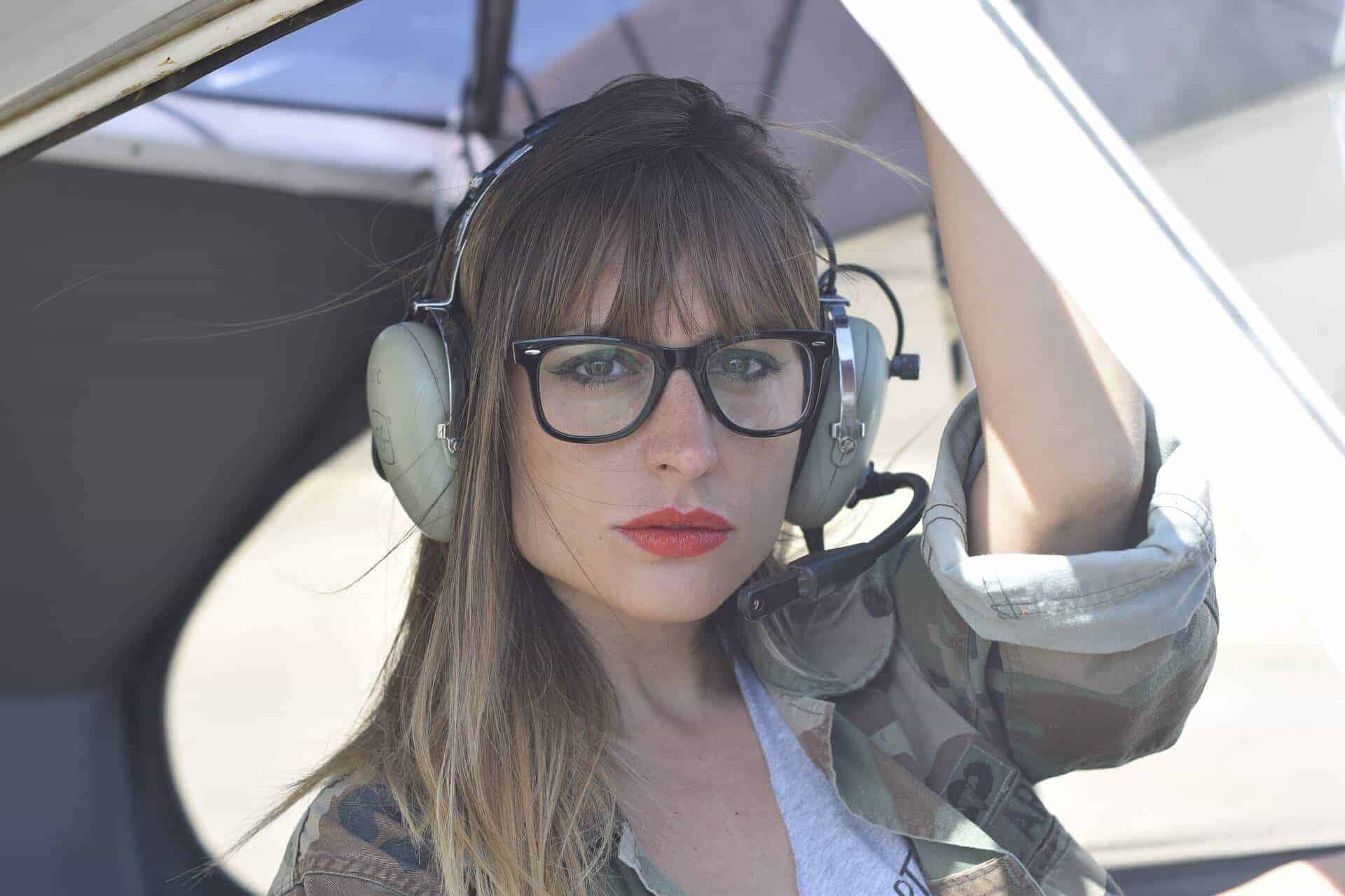 Pilot with headphones in airplane on a license-free photo of good quality