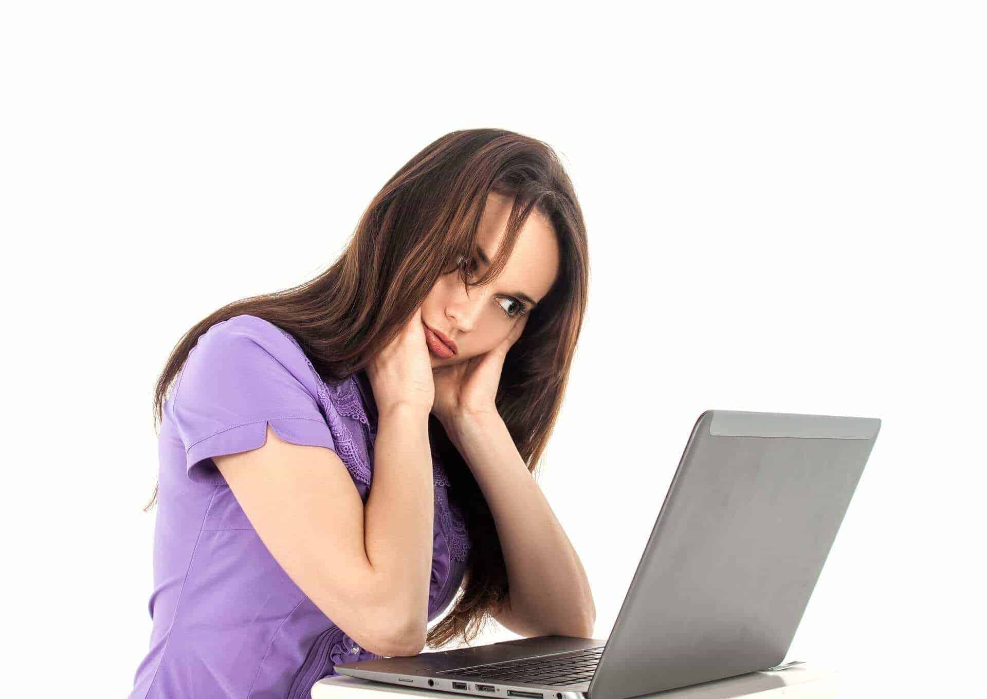 Woman sitting helplessly in front of a notebook on a free stock photo