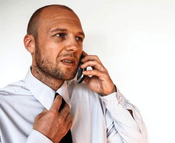 Personal profile for social media stress test: stressed man with tie on the phone