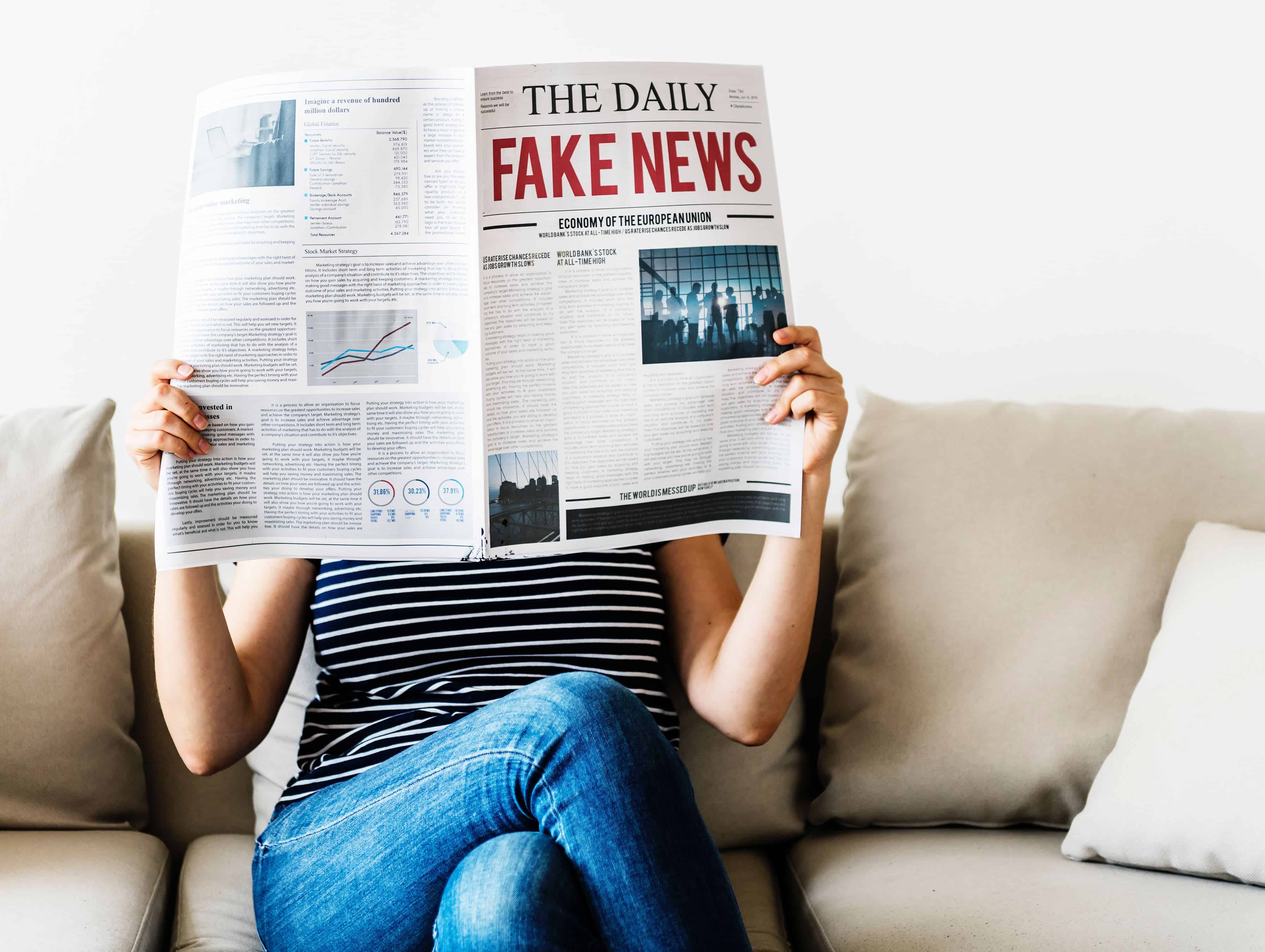 Woman with newspaper, title: The Daily Fake News